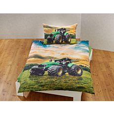 Bettwäsche mit grossem Traktor auf grüner Wiese